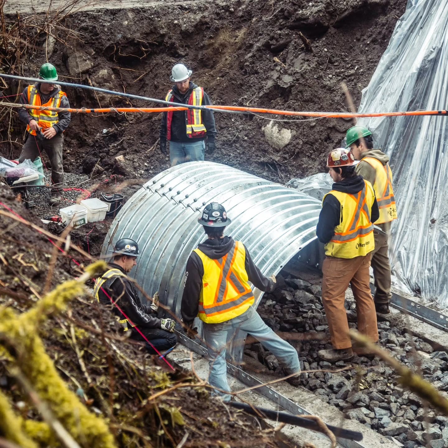 Radius Excavation crew installing a large culvert section on site